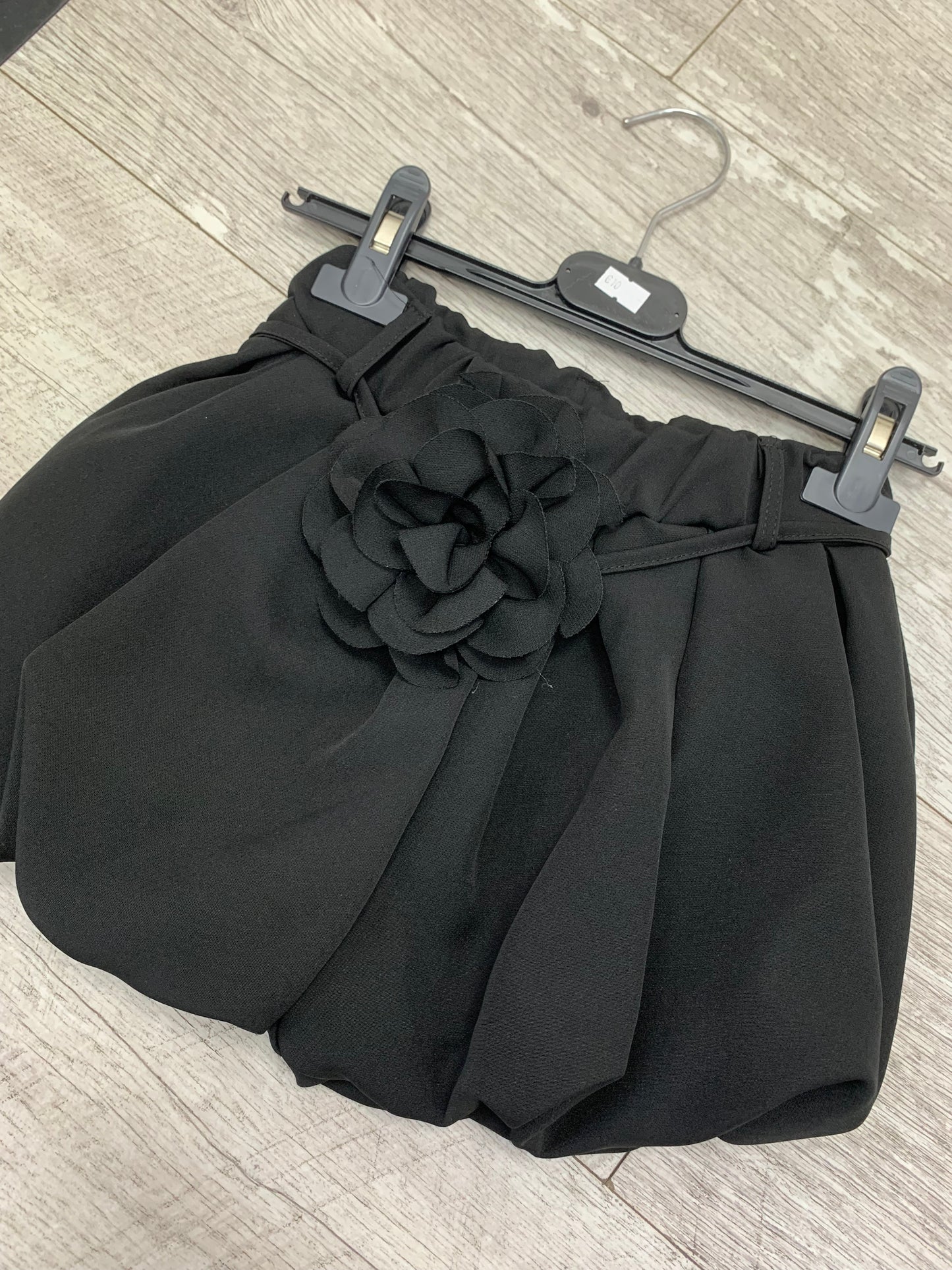 Girls black puffball style shorts with flower tie belt